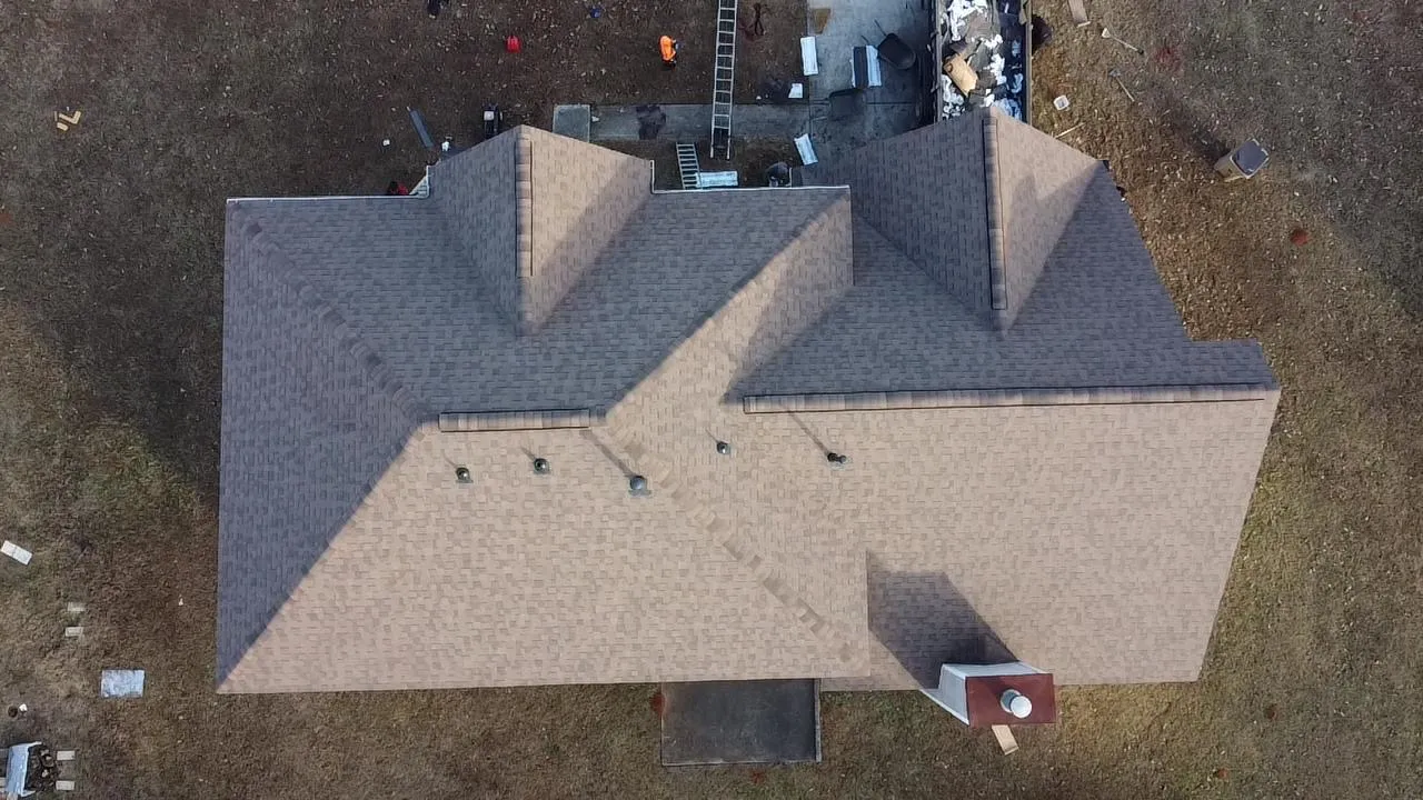 Completed tan architectural shingle roof, drone view