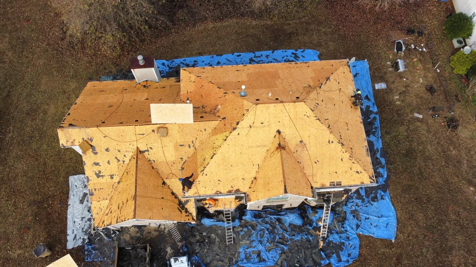 Roof tear-off in progress, decking exposed